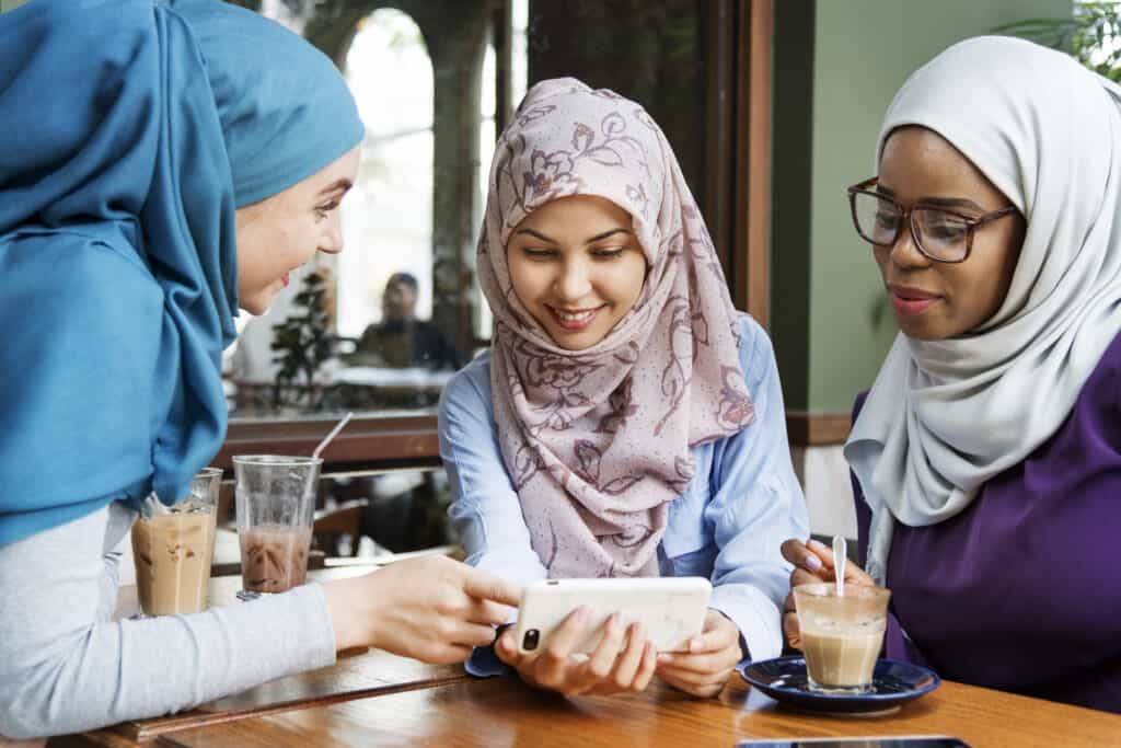 group of-Muslim womrn looking at smartphone-